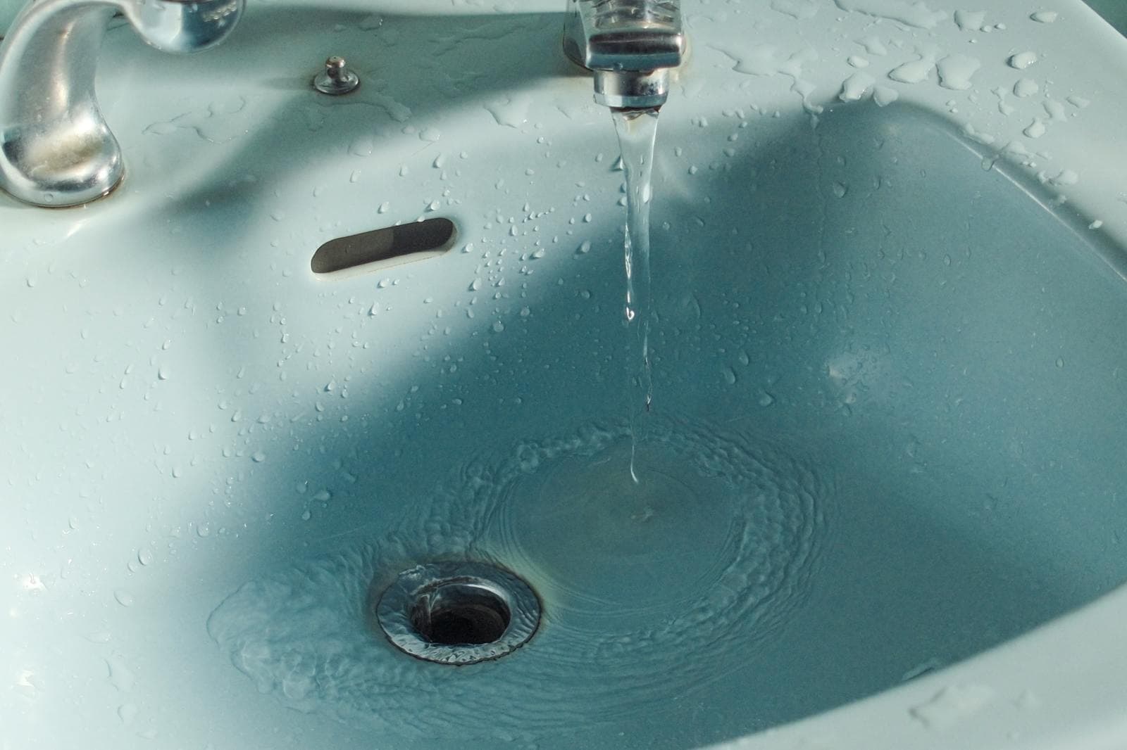Running water in a bathroom sink during plumbing work