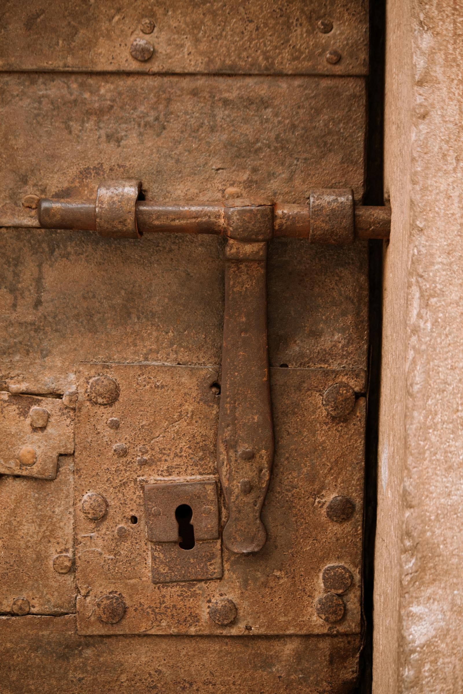 Close-up of a worn door lock and keyhole
