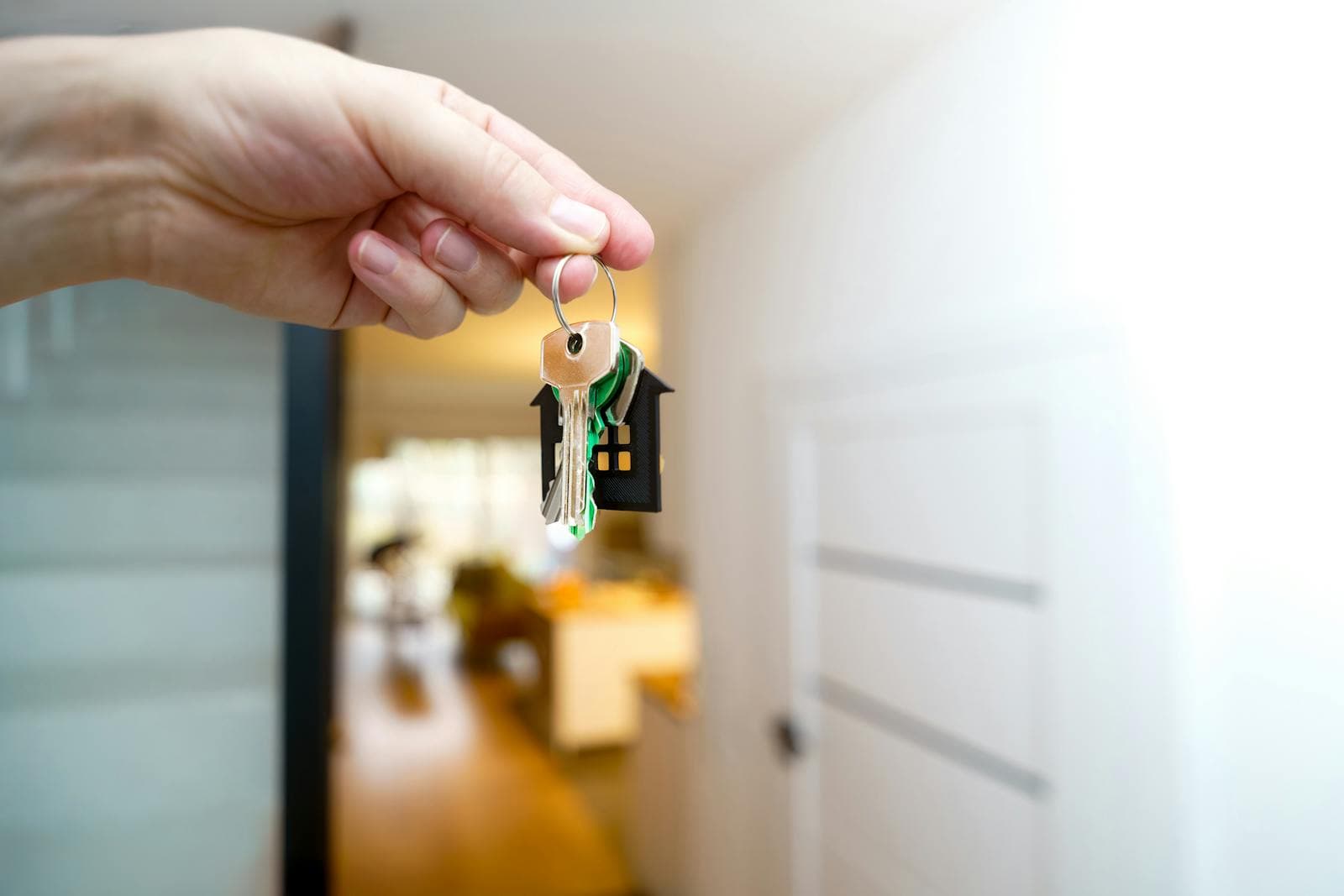 Hand holding keys inside a property